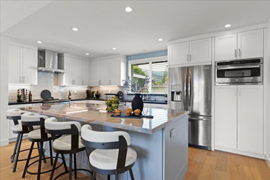 Example of a large trendy u-shaped medium tone wood floor and brown floor eat-in kitchen design in San Francisco with an undermount sink, shaker cabinets, white cabinets, quartzite countertops, multicolored backsplash, porcelain backsplash, stainless steel appliances, an island and multicolored countertops
