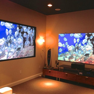 Home theater - large contemporary open concept carpeted and brown floor home theater idea in New Orleans with beige walls and a wall-mounted tv