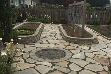 Photo of a traditional backyard full sun garden in Seattle with a garden path and concrete pavers.