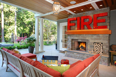 Example of a classic patio design in Seattle with a roof extension and a fireplace