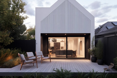 This is an example of a mid-sized contemporary one-storey white house exterior in Melbourne with concrete fiberboard siding, a gable roof, a metal roof, a white roof and clapboard siding.