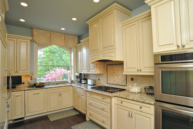 Enclosed kitchen - traditional u-shaped dark wood floor and brown floor enclosed kitchen idea in DC Metro with an undermount sink, raised-panel cabinets, beige cabinets, granite countertops, beige backsplash, subway tile backsplash, stainless steel appliances and no island
