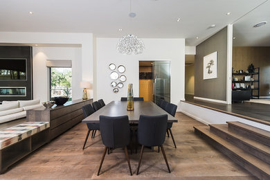 Inspiration for an expansive contemporary open plan dining in Brisbane with white walls and medium hardwood floors.