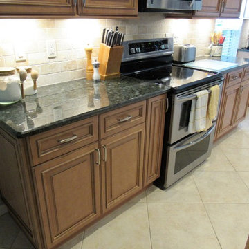 Galaxy Pecan cabinets with peacock green granite