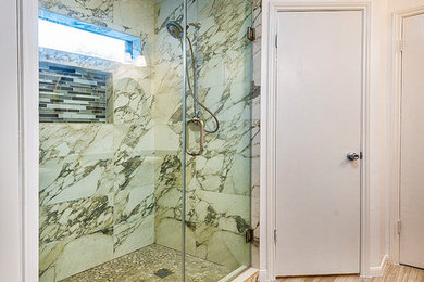 Double shower - mid-sized traditional master black and white tile and porcelain tile porcelain tile and brown floor double shower idea in Houston with raised-panel cabinets, gray cabinets, white walls, a hinged shower door, a one-piece toilet, a drop-in sink and granite countertops