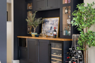 Inspiration for a medium sized contemporary open plan dining room in Hampshire with blue walls, porcelain flooring, beige floors and a feature wall.