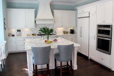 Example of a mid-sized transitional l-shaped dark wood floor and brown floor open concept kitchen design in Jacksonville with shaker cabinets, white cabinets, marble countertops, white backsplash, marble backsplash, paneled appliances, an island and a farmhouse sink
