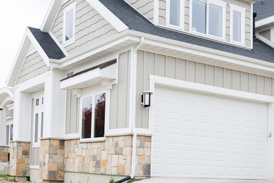 Example of a large transitional gray three-story exterior home design in Salt Lake City