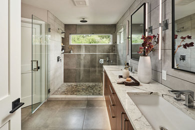 Inspiration for a medium sized contemporary ensuite bathroom in Portland with flat-panel cabinets, dark wood cabinets, an alcove shower, grey tiles, porcelain tiles, beige walls, porcelain flooring, engineered stone worktops, grey floors, a hinged door, beige worktops, a shower bench, double sinks and a floating vanity unit.