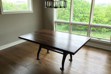 Inspiration for a large contemporary dark wood floor enclosed dining room remodel in Omaha with gray walls