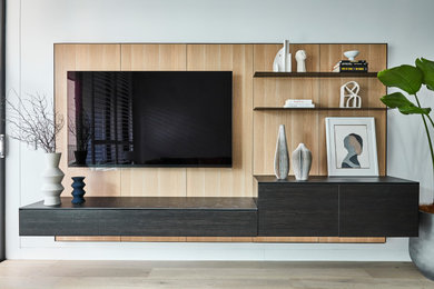 Kleines Modernes Wohnzimmer mit weißer Wandfarbe, hellem Holzboden und Multimediawand in Sydney