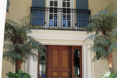 Example of a classic slate floor entryway design in Jacksonville with a medium wood front door
