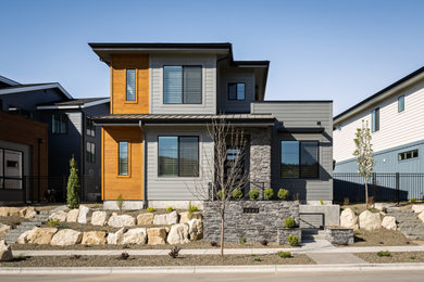 Small transitional gray two-story mixed siding house exterior photo in Boise with a metal roof and a black roof