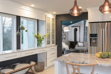 Eat-in kitchen - mid-sized scandinavian l-shaped eat-in kitchen idea in Manchester with an undermount sink, flat-panel cabinets, white cabinets, quartz countertops, multicolored backsplash, glass sheet backsplash, stainless steel appliances and an island