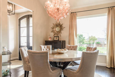 Inspiration for a transitional laminate floor and brown floor enclosed dining room remodel in Austin with beige walls