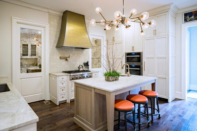 This is an example of a traditional u-shaped open plan kitchen in Other with an undermount sink, shaker cabinets, white cabinets, marble benchtops, beige splashback, panelled appliances, dark hardwood floors, with island, brown floor and beige benchtop.