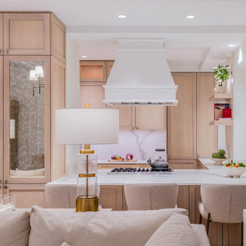 Open-concept kitchen with custom wood cabinetry and breakfast bar