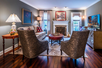 Mid-sized transitional formal open concept living room in New York with grey walls, dark hardwood floors, a standard fireplace, a tile fireplace surround, a freestanding tv and brown floor.
