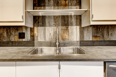 Kitchen - mid-sized contemporary galley medium tone wood floor and brown floor kitchen idea in Denver with a drop-in sink, flat-panel cabinets, white cabinets, concrete countertops, brown backsplash, wood backsplash, stainless steel appliances, no island and brown countertops
