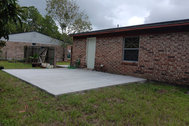 Patio - mid-sized traditional backyard concrete patio idea in Jacksonville with no cover