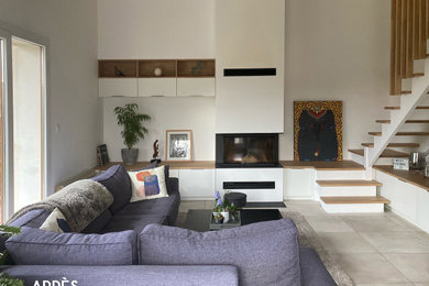 Cette photo montre un salon mansardé ou avec mezzanine tendance avec un sol en carrelage de céramique, une cheminée double-face, un sol beige, poutres apparentes et un escalier.