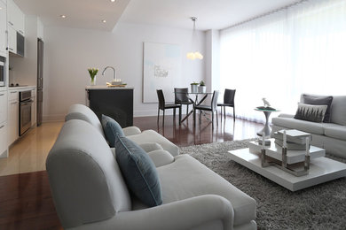Inspiration for a large modern formal and open concept porcelain tile and beige floor living room remodel in Montreal with white walls, no fireplace and a wall-mounted tv