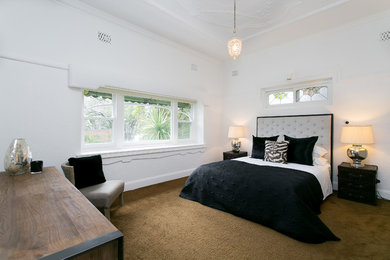 This is an example of a contemporary master bedroom in Melbourne with carpet.