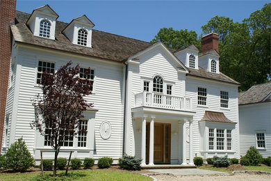 Inspiration for a mid-sized timeless white two-story vinyl exterior home remodel in New York with a shingle roof