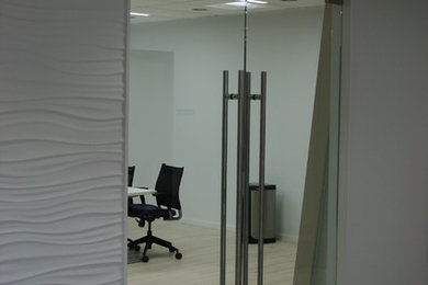 Example of a mid-sized minimalist freestanding desk light wood floor study room design in Philadelphia with white walls