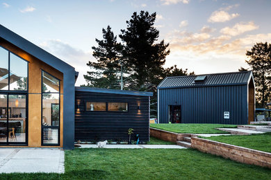 Inspiration for a small contemporary one-storey black exterior in Auckland with wood siding and a gable roof.