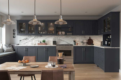 Design ideas for a mid-sized contemporary l-shaped eat-in kitchen in Other with a drop-in sink, shaker cabinets, blue cabinets, quartzite benchtops, white splashback, engineered quartz splashback, stainless steel appliances, laminate floors, no island, brown floor and white benchtop.