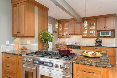 Eat-in kitchen - large transitional u-shaped light wood floor eat-in kitchen idea in Vancouver with a double-bowl sink, recessed-panel cabinets, medium tone wood cabinets, quartzite countertops, gray backsplash, subway tile backsplash, stainless steel appliances and a peninsula