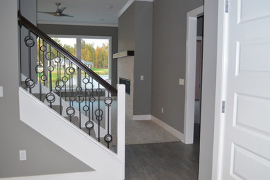 Design ideas for a mid-sized modern carpeted straight staircase in Other with carpet risers and metal railing.