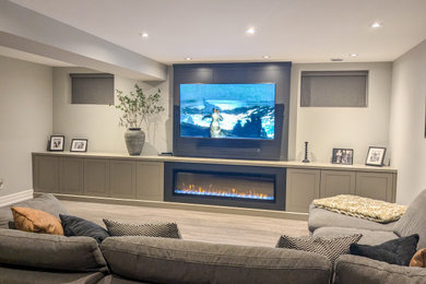Basement - modern basement idea in Toronto with gray walls and a standard fireplace