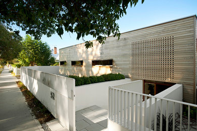 Mid-sized contemporary split-level white exterior in Perth with wood siding and a flat roof.