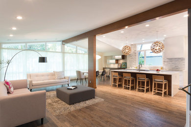 Mid-sized trendy single-wall medium tone wood floor and brown floor open concept kitchen photo in Other with flat-panel cabinets, white cabinets, gray backsplash, an island, an undermount sink, matchstick tile backsplash and stainless steel appliances