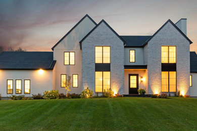 Contemporary white two-story house exterior idea in Ottawa with a shingle roof and a black roof