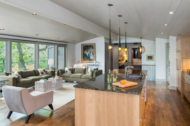 Example of a mid-sized trendy open concept medium tone wood floor living room design in Austin with beige walls and a corner fireplace