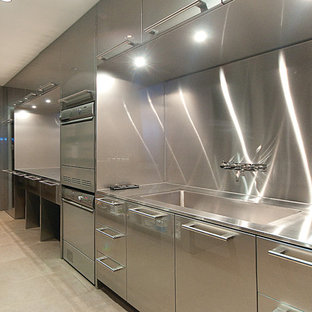 Photo of an expansive u-shaped separated utility room in Vancouver with an integrated sink, flat-panel cabinets, stainless steel cabinets and stainless steel worktops.