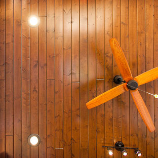 Design ideas for a mid-sized country backyard patio in Houston with an outdoor kitchen, stamped concrete and a roof extension.