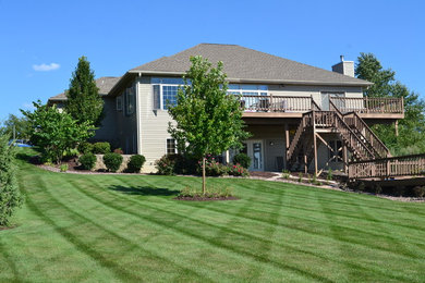 Design ideas for a mid-sized traditional full sun backyard landscaping in Milwaukee with decking.
