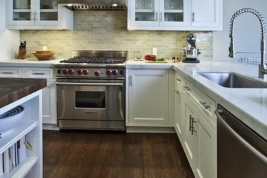 Inspiration for a large farmhouse l-shaped dark wood floor and brown floor eat-in kitchen remodel in Raleigh with an undermount sink, shaker cabinets, white cabinets, wood countertops, beige backsplash, stone tile backsplash, stainless steel appliances and an island