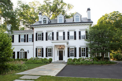 Photo of an expansive traditional three-storey white house exterior in New York with wood siding, a gable roof and a tile roof.