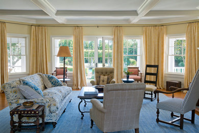 Large elegant medium tone wood floor living room photo in New York with yellow walls and no tv