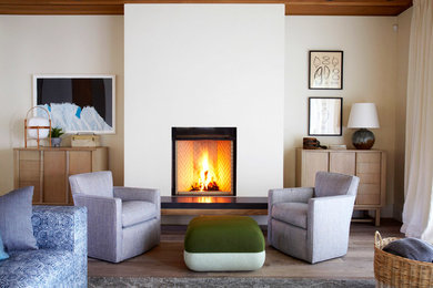 Living room - coastal formal light wood floor living room idea in Santa Barbara with beige walls, a standard fireplace and no tv
