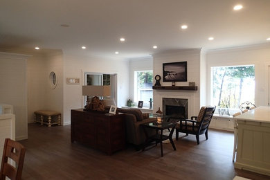 Mid-sized mountain style open concept medium tone wood floor living room photo in Toronto with white walls, a standard fireplace, a stone fireplace and a wall-mounted tv
