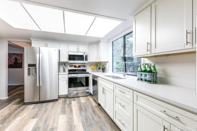 Inspiration for a mid-sized contemporary l-shaped kitchen pantry remodel in Seattle with shaker cabinets and white cabinets