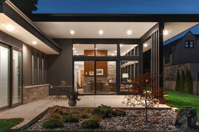 Inspiration for a large modern gray one-story stone and clapboard exterior home remodel in Milwaukee