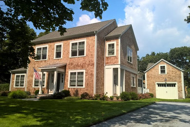 Beach style brown two-story wood exterior home photo in New York