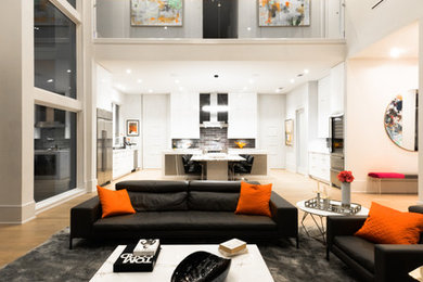 Inspiration for a large modern open concept light wood floor and beige floor living room remodel in New Orleans with white walls, a standard fireplace and no tv